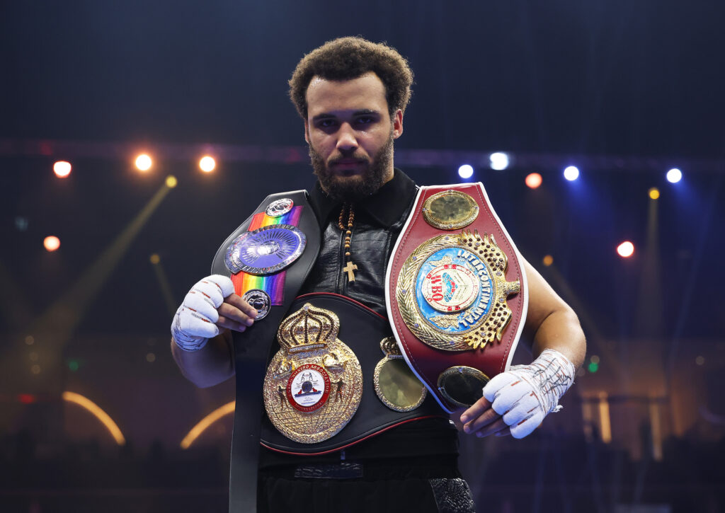 Moses Itauma celebrates victory with his belts