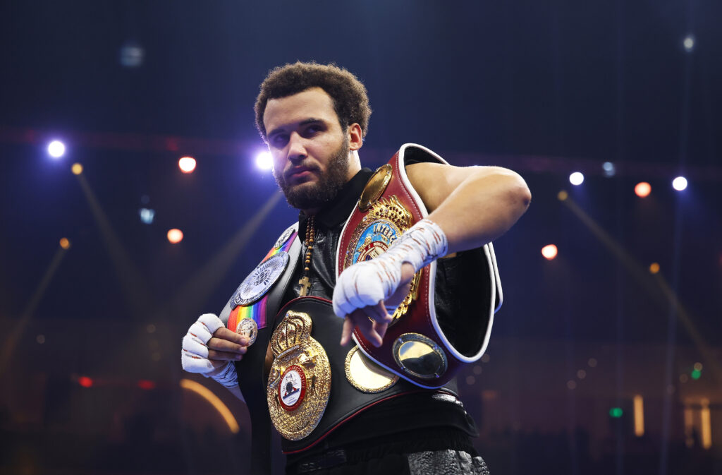 Moses Itauma celebrates victory with his belts