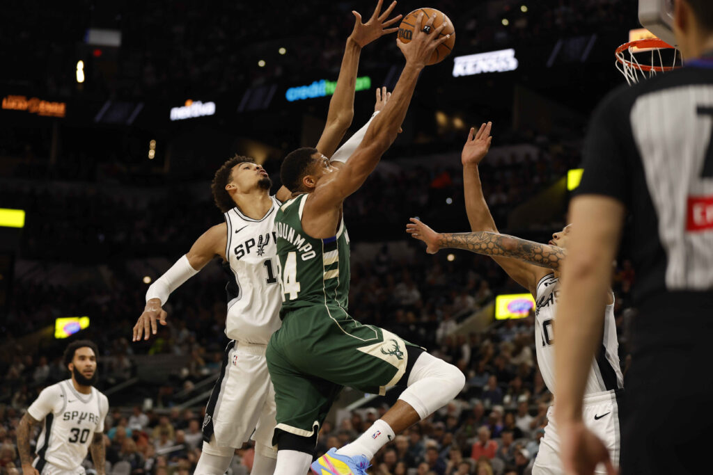Giannis Antetokounmpo #34 of the Milwaukee Bucks drives on Victor Wembanyama #1 of the San Antonio Spurs