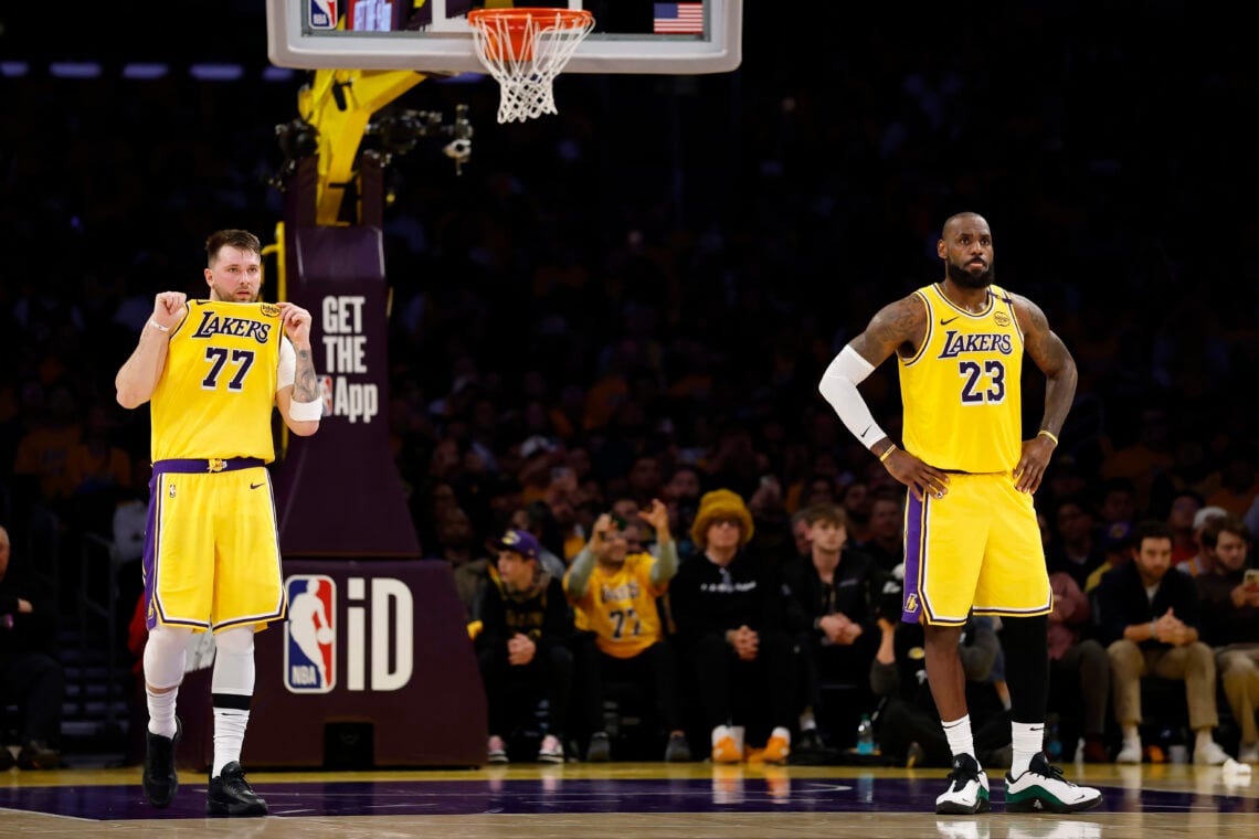 Luka Doncic #77 and LeBron James #23 of the Los Angeles Lakers look on