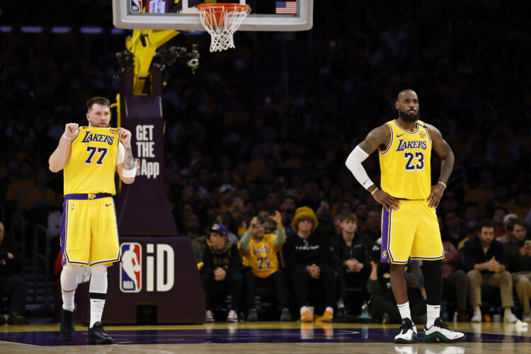 Luka Doncic #77 and LeBron James #23 of the Los Angeles Lakers look on