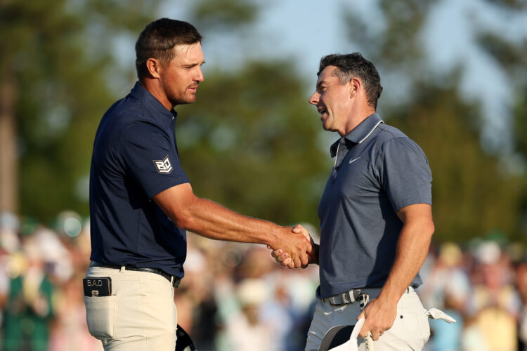Rory McIlroy of Northern Ireland shakes hands with Bryson DeChambeau of the United States