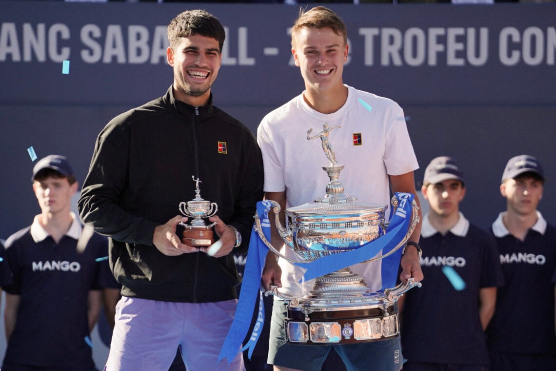 Holger Rune and Carlos Alcaraz holding their trophies from ATP Barcelona