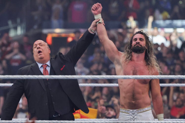 Paul Heyman lifting Seth Rollins' hand after he beat CM Punk and Roman Reigns at WWE's WrestleMania 41