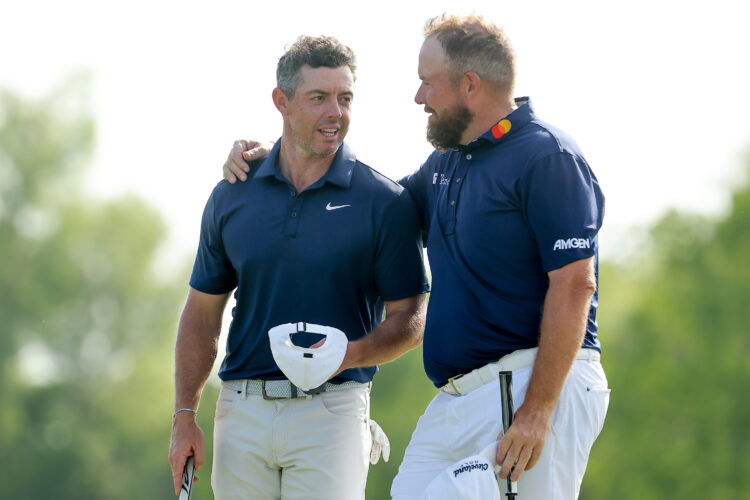 Rory McIlroy of Northern Ireland and Shane Lowry of Ireland watch on at the Zurich Classic