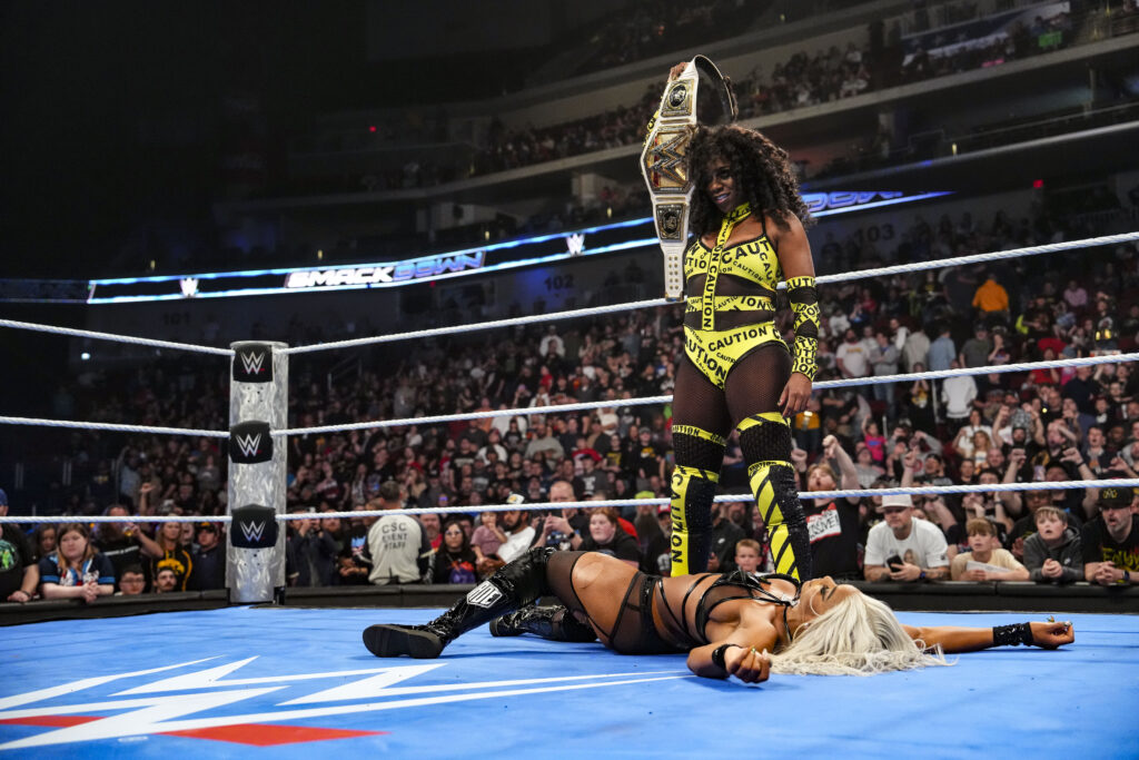 Naomi holding the Women's Championship over Jade Cargill on WWE SmackDown