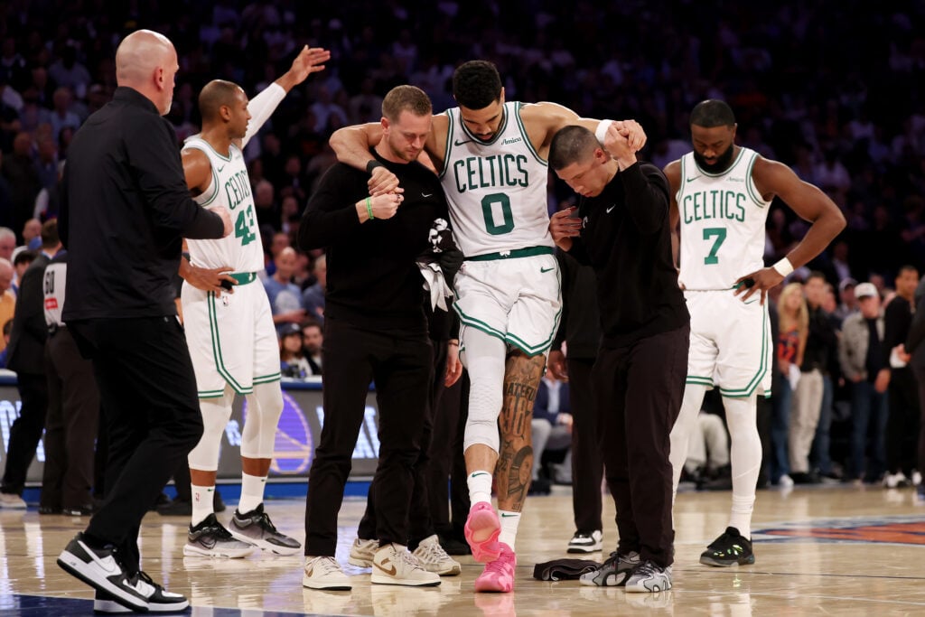 Jayson Tatum of the Boston Celtics is assisted off court after being injured against the New York Knicks