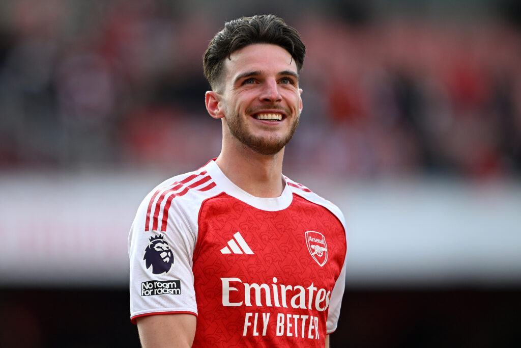 Declan Rice smiles during a match between Arsenal and Newcastle United in the Premier League.