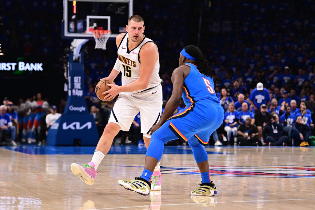 Nikola Jokic #15 of the Denver Nuggets dribbles the ball against Lu Dort #5 of the Oklahoma City Thunder