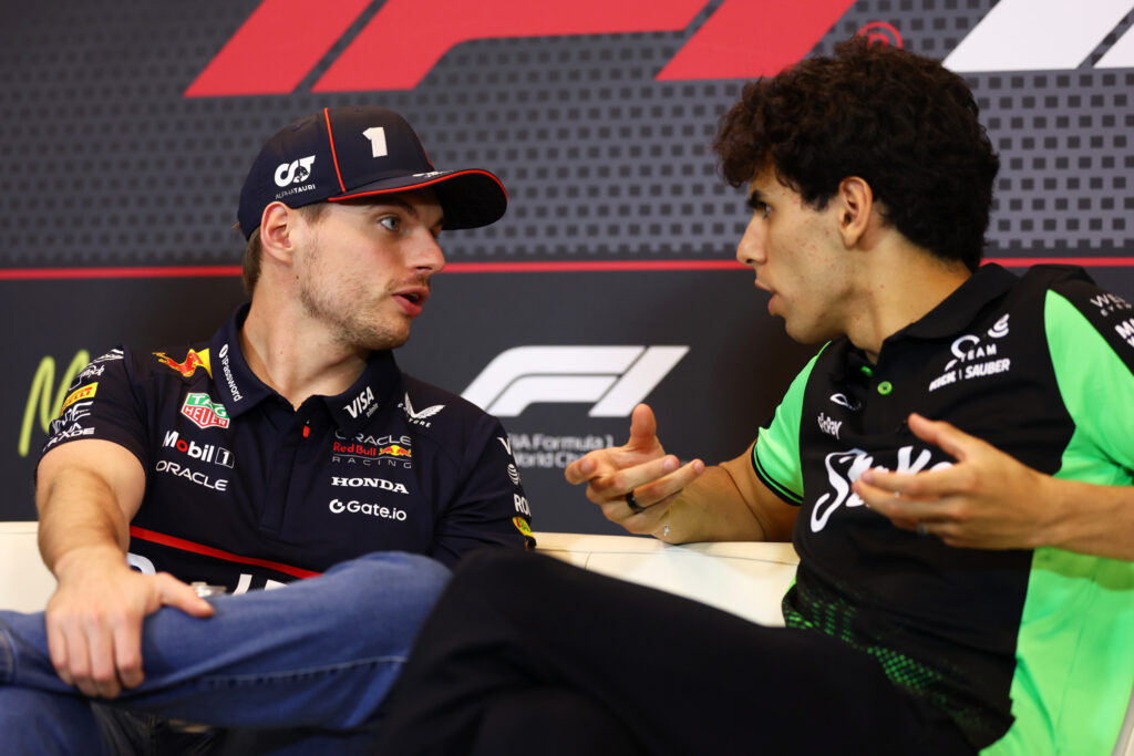 Max Verstappen of the Netherlands and Oracle Red Bull Racing talks with Gabriel Bortoleto of Brazil and Stake F1 Team Kick Sauber in the Drivers Press Conference