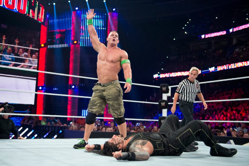John Cena about to hit a Five Knuckle Shuffle on Roman Reigns at WWE Battleground in 2014