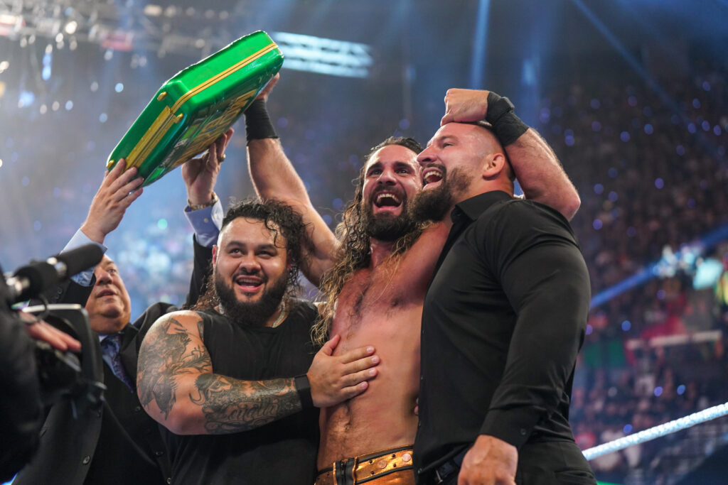 Seth Rollins celebrating his Money in the Bank win with Bronson Reed, Paul Heyman, and Bron Breakker