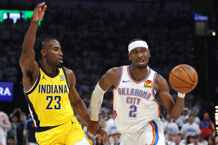 Shai Gilgeous-Alexander of the Oklahoma City Thunder dribbles past Benedict Mathurin during Game 2 of the NBA Finals.
