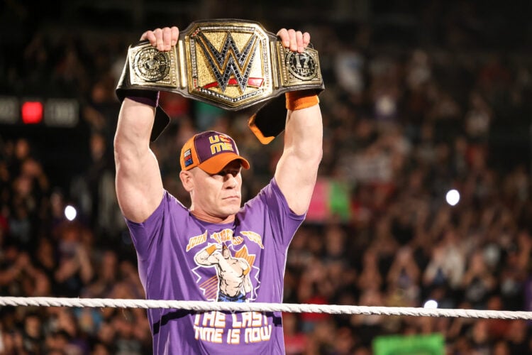 John Cena holding the WWE Championship aloft on WWE Monday Night RAW