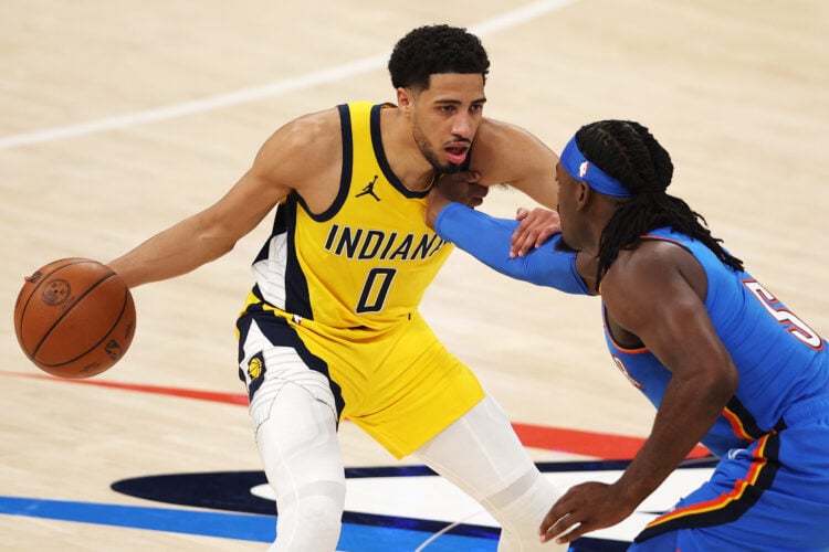 Tyrese Haliburton fights off Luguentz Dort of the Oklahoma City Thunder as he brings the ball up for the Pacers.