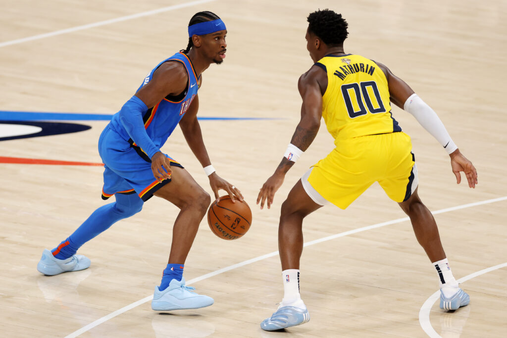 Shai Gilgeous-Alexander of the Oklahoma City Thunder dribbles past Benedict Mathurin during Game 2 of the NBA Finals.