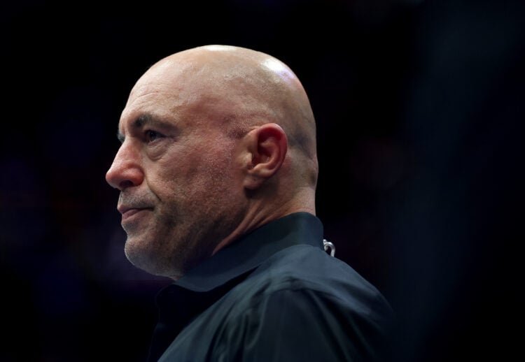 Joe Rogan enters the Octagon while commentating during UFC 316 in New Jersey