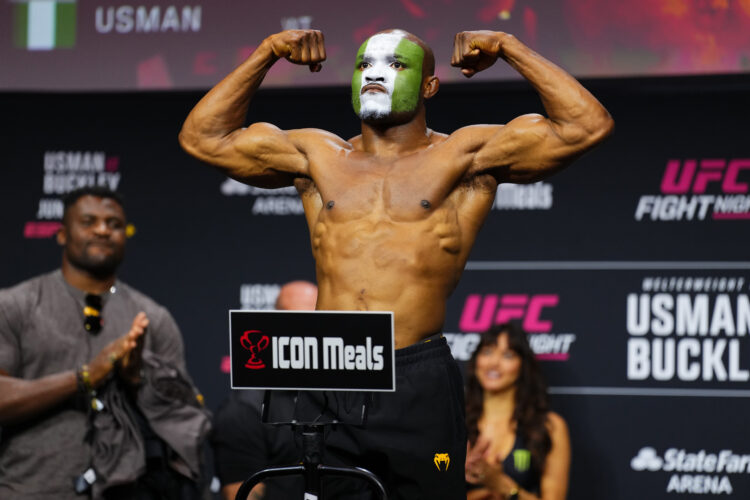 Kamaru Usman poses on the scale during the UFC Atlanta ceremonial weigh-ins