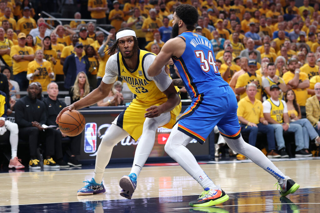 Myles Turner #33 of the Indiana Pacers drives to the basket against Kenrich Williams #34 of the Oklahoma City Thunder