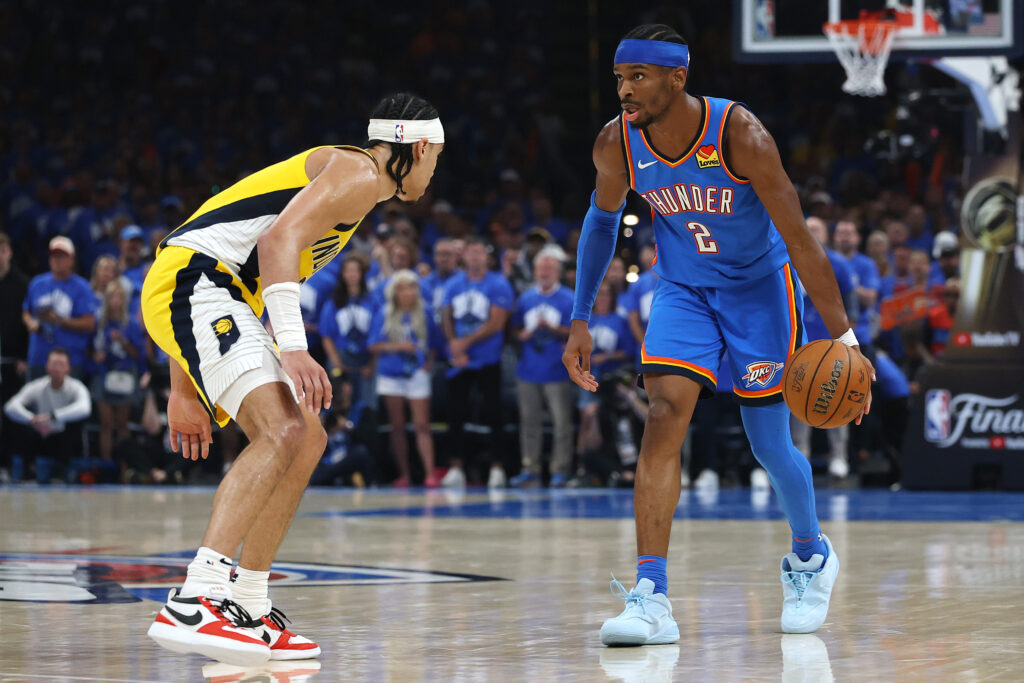 Shai Gilgeous-Alexander #2 of the Oklahoma City Thunder is defended by Andrew Nembhard #2 of the Indiana Pacers
