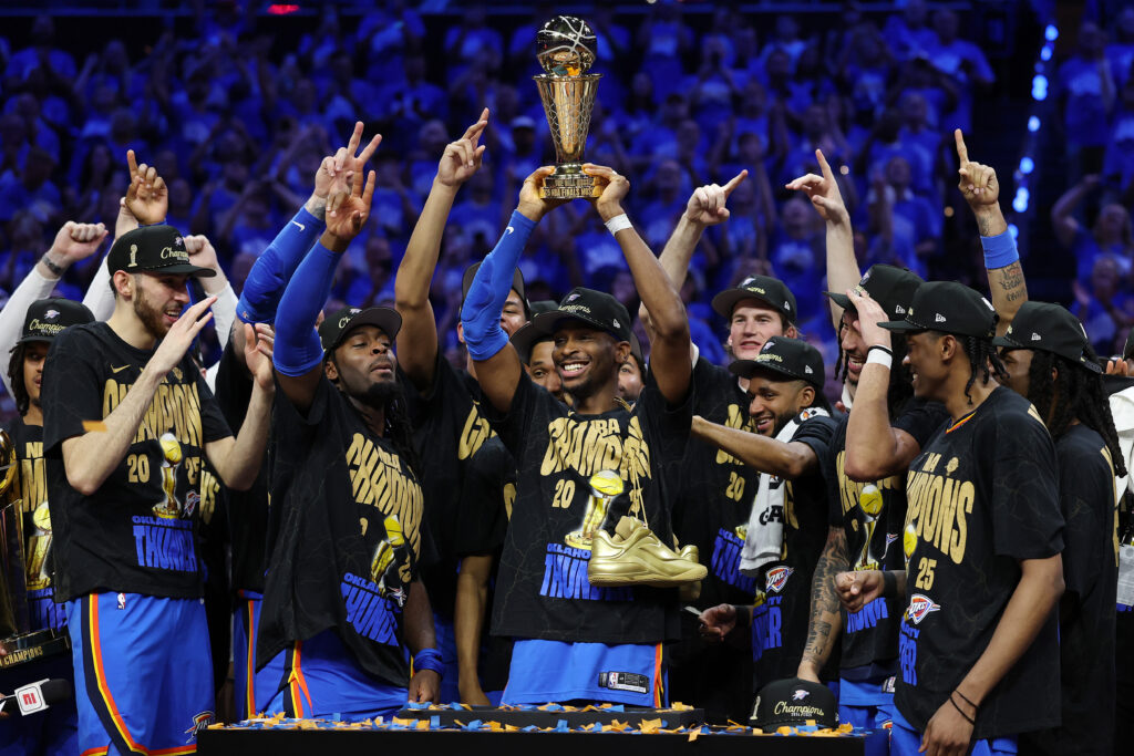 Shai Gilgeous-Alexander #2 of the Oklahoma City Thunder celebrates with the NBA Finals Most Valuable Player trophy