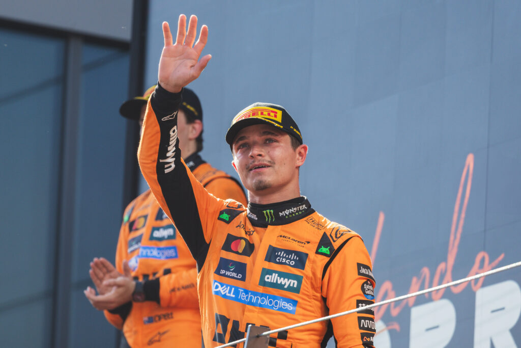Lando Norris of McLaren F1 Team waves while on the podium during Formula One Austrian Grand Prix