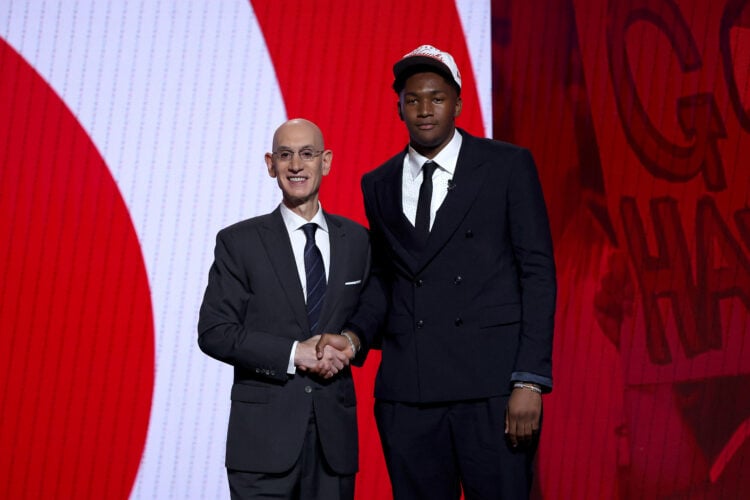 Derik Queen shakes hands with NBA commissioner Adam Silver after being drafted thirteenth overall by the Atlanta Hawks.