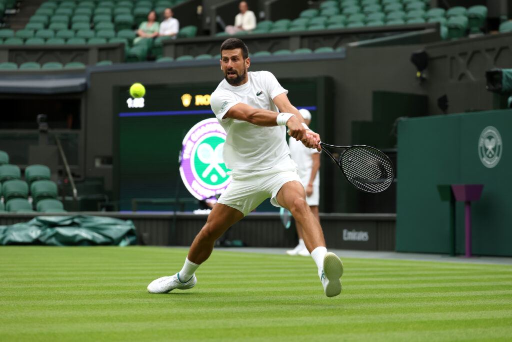 Novak Djokovic plays a backhand during practice prior to The Championships Wimbledon 2025