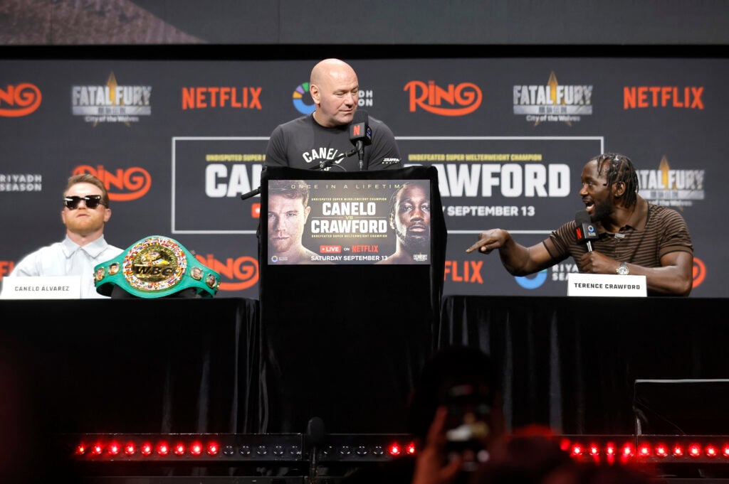 Terence Crawford speaks to Canelo Alvarez during the press conference to announce their fight
