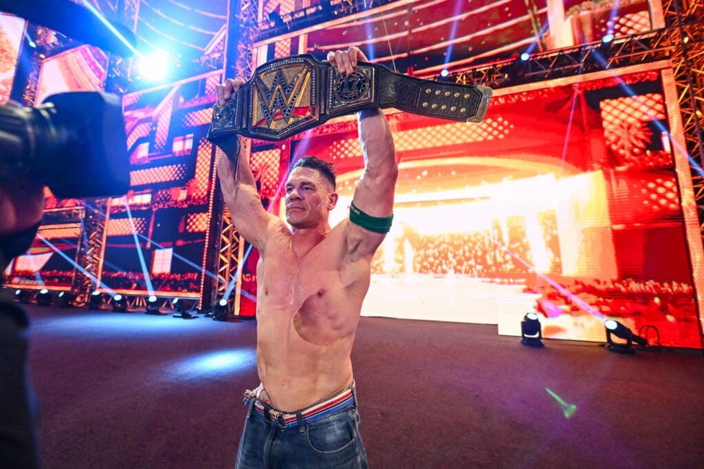 John Cena lifting the WWE Championship aloft after defeating CM Punk at Night Of Champions