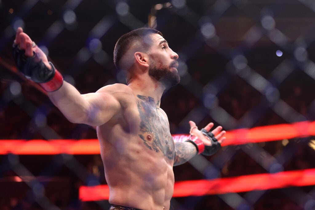 Ilia Topuria celebrates after his knockout win over Charles Oliveira at UFC 317