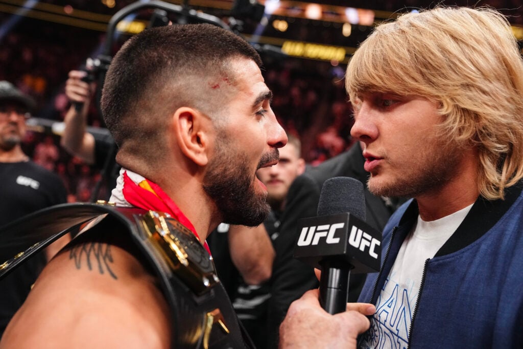 Ilia Topuria faces off with Paddy Pimblett after title fight win against Charles Oliveira at UFC 317