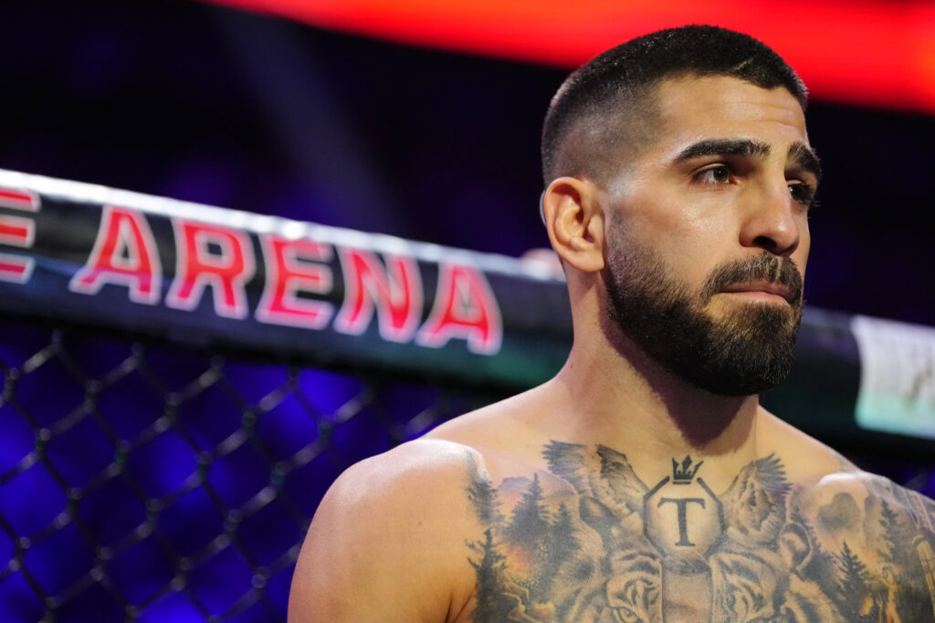 Ilia Topuria enters the Octagon for his lightweight title fight against Charles Oliveira at UFC 317