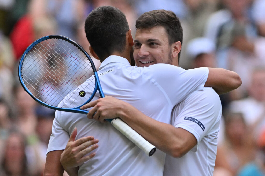Novak Djokovic embraces Miomir Kecmanovic after defeating the Serbian at Wimbledon 2025