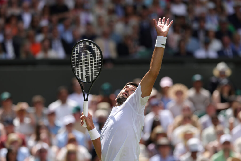 Novak Djokovic of Serbia serves against Daniel Evans of Great Britain during the Gentlemen's Singles second round match