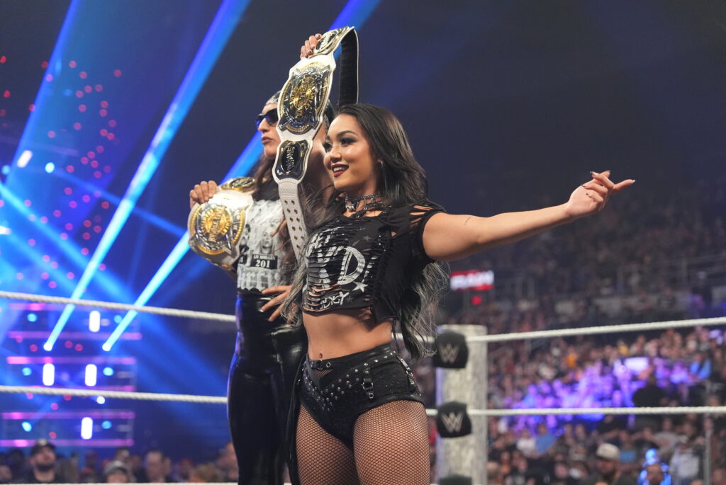 Raquel Rodriguez and Roxanne Perez holding the Tag Team Championships aloft on WWE Monday Night RAW