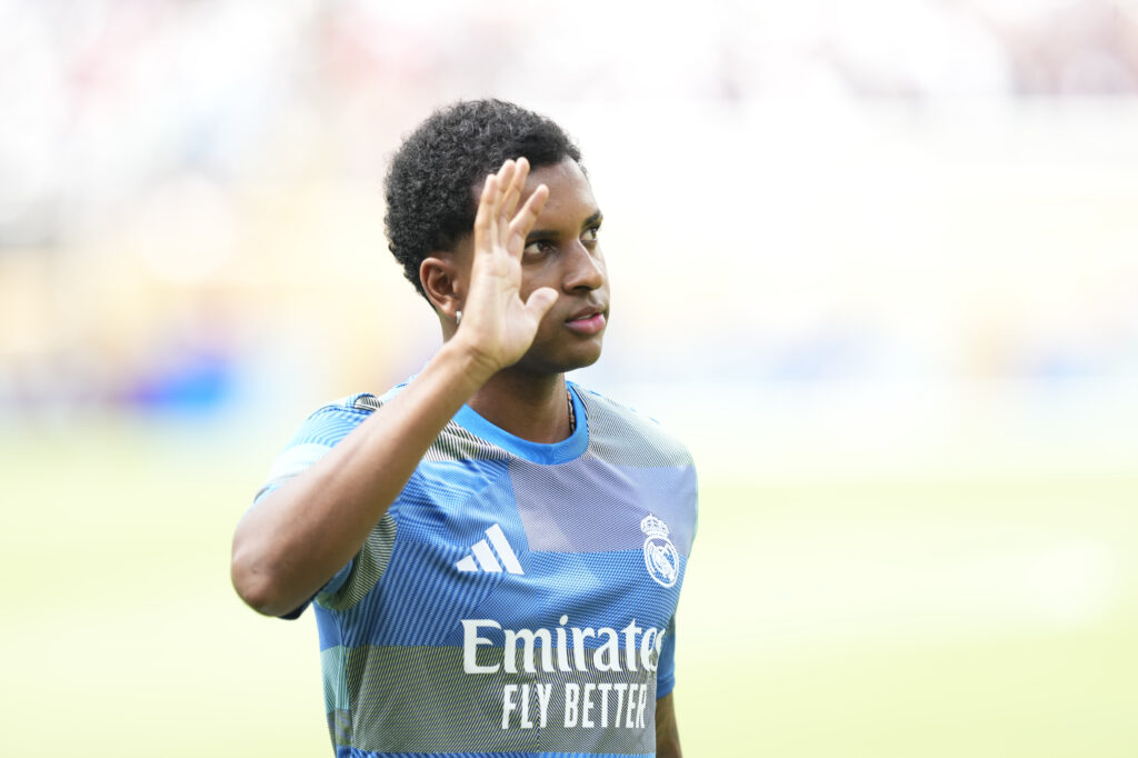 Rodrygo waves during a Real Madrid warm-up session