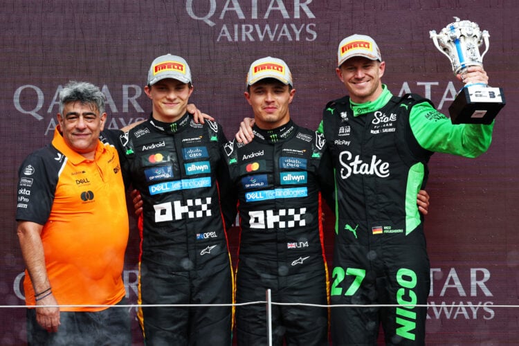 Lando Norris and Oscar Piastri of McLaren F1 Team and technical director Peter Prodromou seen on the podium after the Formula One British Grand Pri...