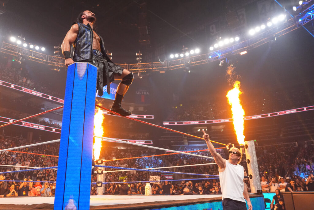 Drew McIntyre posing on the top turnbuckle with Logan Paul pointing at him at WWE Saturday Night's Main Event