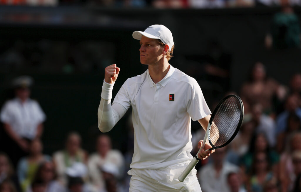 Jannik Sinner looking toward his box after winning a point against Carlos Alcaraz in the Wimbledon final