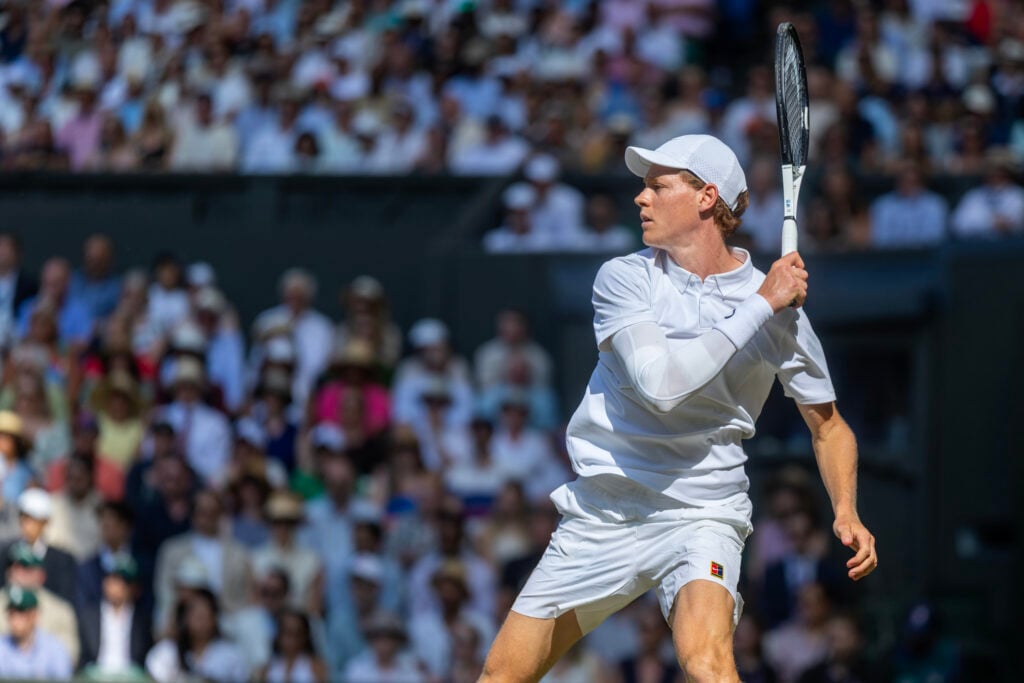 Jannik Sinner striking the ball at the 2025 Wimbledon final