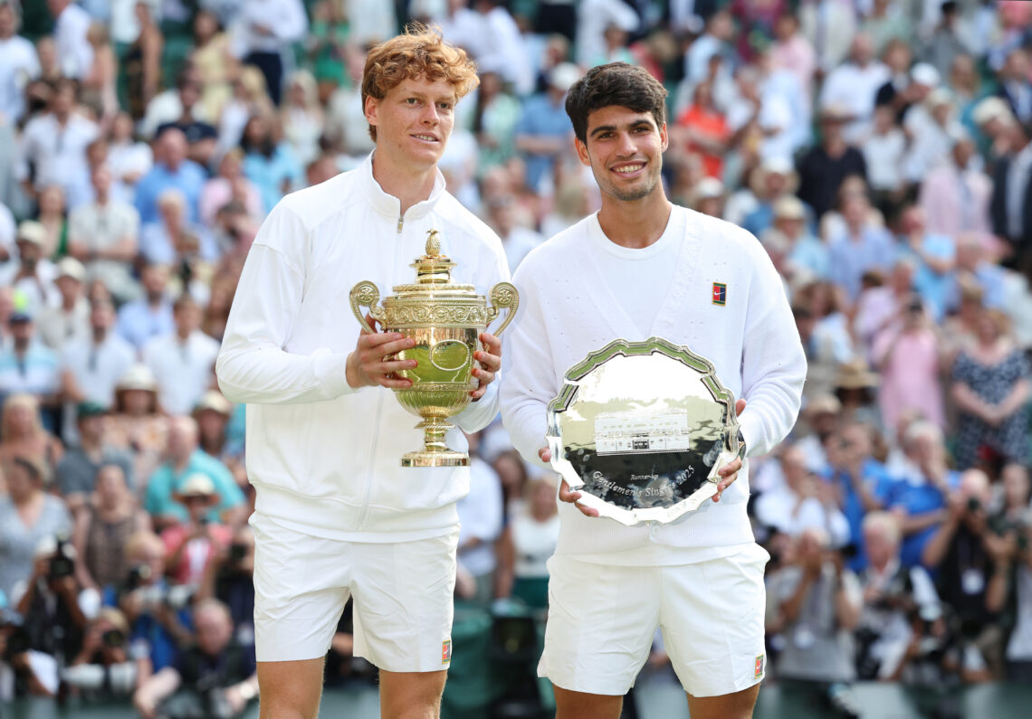 Jannik Sinner and Carlos Alcaraz holding their respective Wimbledon trophies in 2025