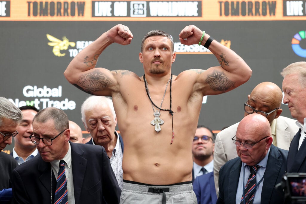 Oleksandr Usyk poses for a photograph as he weighs