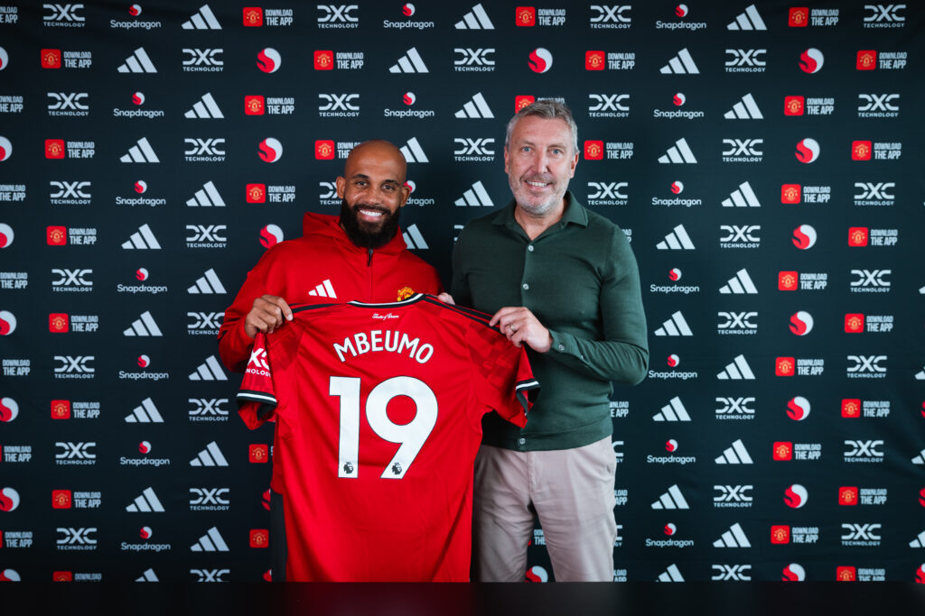 Bryan Mbeumo poses after signing for Manchester United
