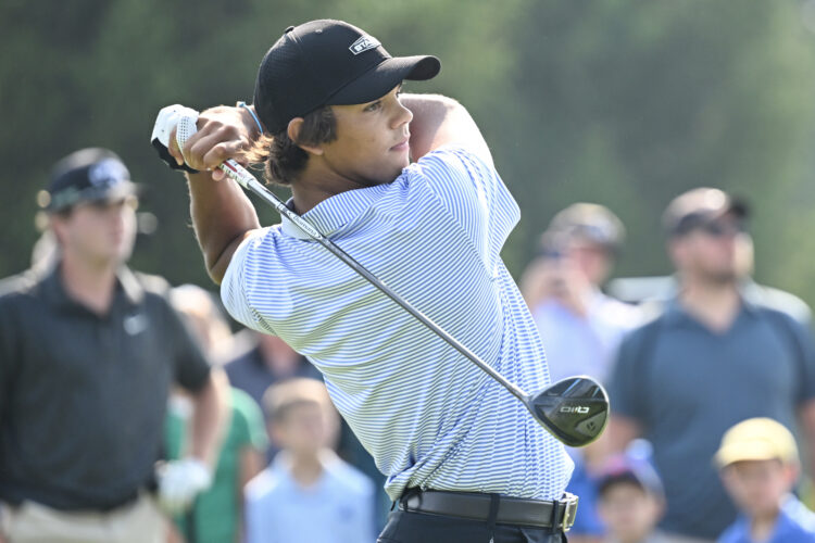Charlie Woods hits a tee shot
