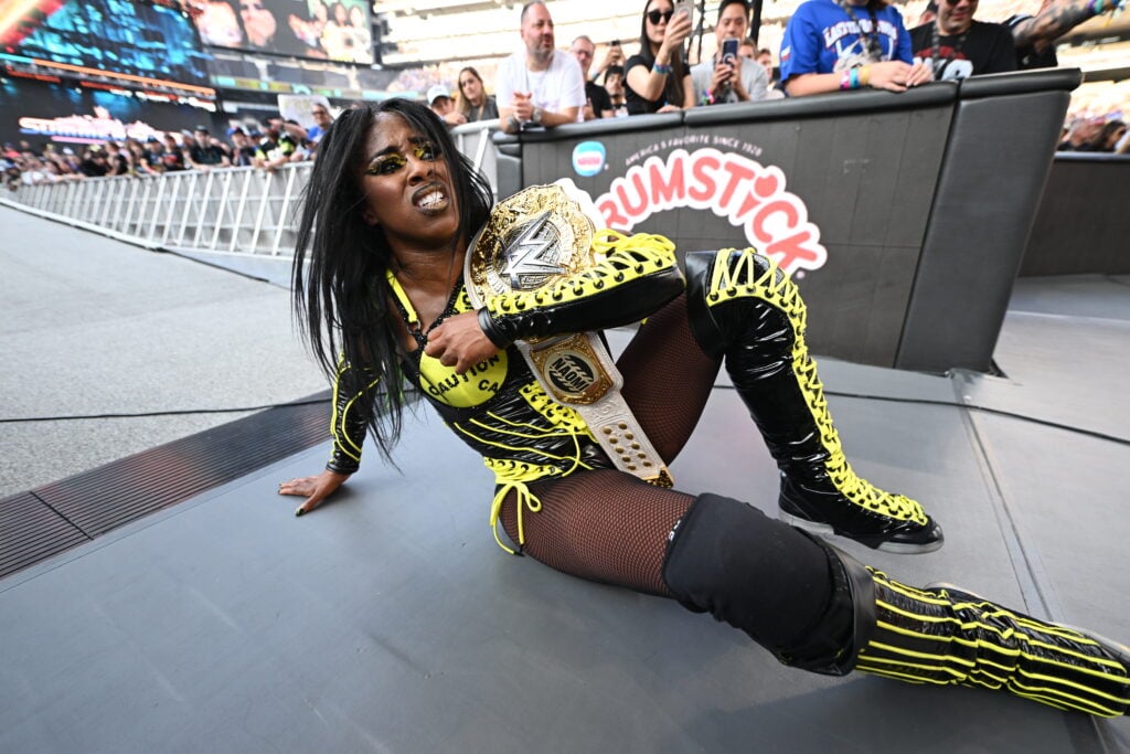 Naomi clutching her Women's World Championship at WWE SummerSlam in 2025