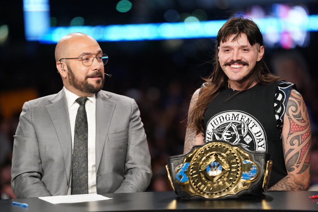 Dominik Mysterio speaks at the WWE Post Show desk with Big E, Peter Rosenberg, and Joe Tessitore