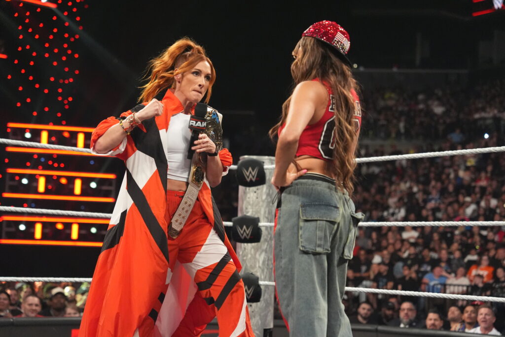 Becky Lynch sucker punching Nikki Bella on WWE Raw
