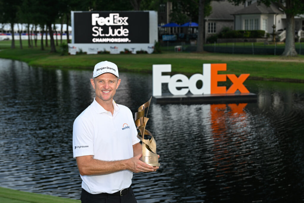 Justin Rose of England holds the trophy on the 18th green after the final round of FedEx St. Jude Championship