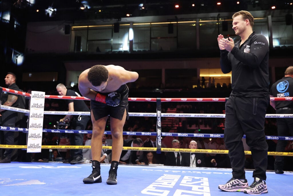 Moses Itauma celebrates victory as his head trainer Ben Davison applauds